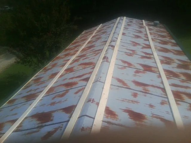 Rusted metal roof panels with new wood purlins before replacement — Storm Damage Roof Repair in Hershey by Roofing Brothers